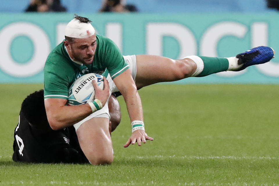 Ireland's Robbie Henshaw is tackled by New Zealand's Sevu Reece during the Rugby World Cup quarterfinal match at Tokyo Stadium in Tokyo, Japan, Saturday, Oct. 19, 2019. (AP Photo/Eugene Hoshiko)