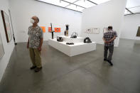 Museum visitor Bill Starkel, of Atlanta, Ga., left, examines artwork at the Institute of Contemporary Art, Tuesday, July 14, 2020, in Boston. The museum reopened for the first time Tuesday, July 14 since the beginning of the coronavirus pandemic, and is open Tuesday, July 14, and Wednesday, July 15, to those with membership. The ICA is to be open with free admission to the public July 16 through July 19, 2020. (AP Photo/Steven Senne)