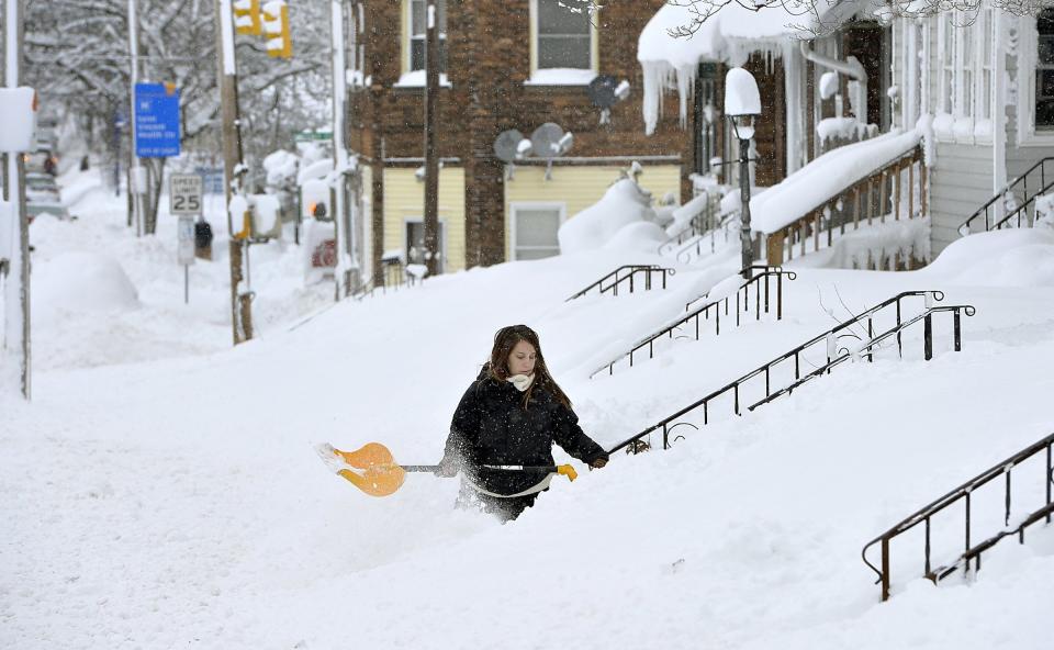 Bitter cold weather takes hold of northern U.S. Rochelle Carlotti, 28, shovels steps near her home after a record snowfall on Tuesday, Dec. 26, 2017, in Erie, Pa. The National Weather Service office in Cleveland says Monday’s storm brought 34 inches of snow, an all-time daily snowfall record for Erie. (Greg Wohlford/Erie Times-News via AP)