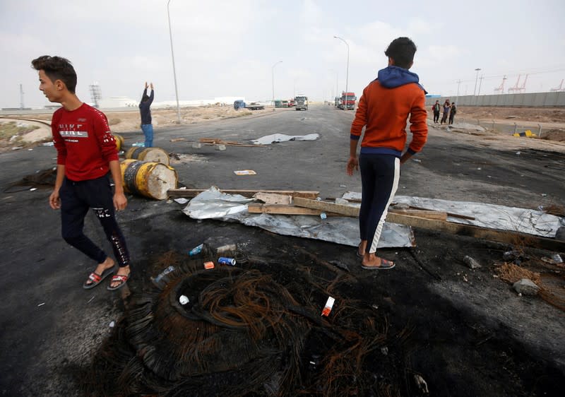 Iraqi demonstrators block the entrance to Umm Qasr Port during the ongoing anti-government protests, south of Basra