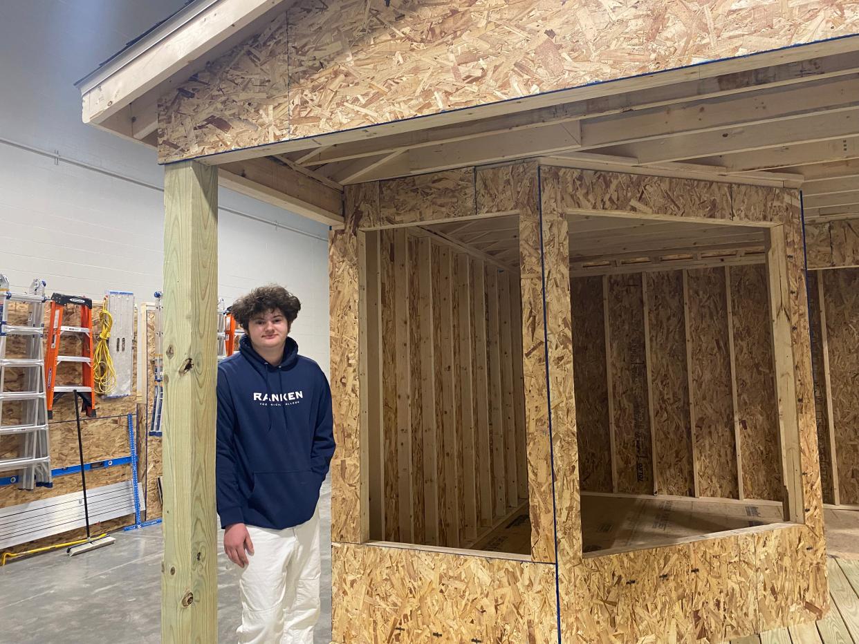 Ranken Technical College carpentry student Max Chegwidden on Friday stands in a structure he is building with another student. The college held a ribbon-cutting ceremony for its Ashland location.