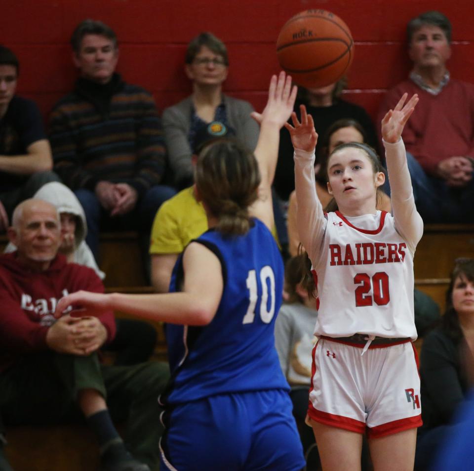Red Hook's Maddie Clements attempts a three point shot over Wallkill's Mia Domingues on January 12, 2024.