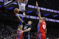 Golden State Warriors' Damion Lee, center, goes up for a shot between Philadelphia 76ers' Matisse Thybulle, left, and Al Horford during the first half of an NBA basketball game Tuesday, Jan. 28, 2020, in Philadelphia. (AP Photo/Matt Slocum)