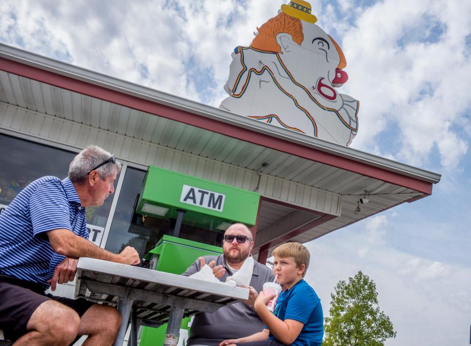 Colton Leman, 9, right, sits with two other generations of the Leman family, including his father, Chad, center, both of Roanoke, and his grandfather, Scott Leman, of Peoria, as they indulge at Emo's Dairy Mart on Sunday, September 27, 2020, the final day of business for the season.