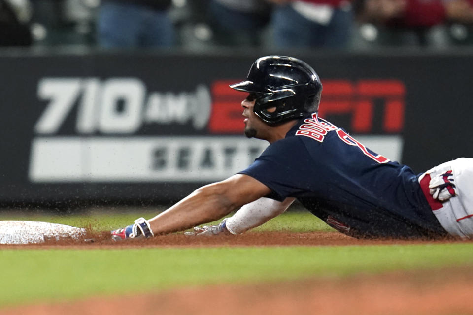 Boston Red Sox's Xander Bogaerts slides into third base with a triple against the Seattle Mariners during the eighth inning of a baseball game Tuesday, Sept. 14, 2021, in Seattle. (AP Photo/Elaine Thompson)