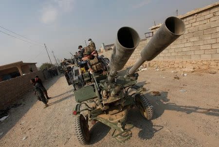 Federal police forces drive military vehicles during an operation against Islamic State militants in Qayyara, south of Mosul October 26, 2016. REUTERS/Alaa Al-Marjani