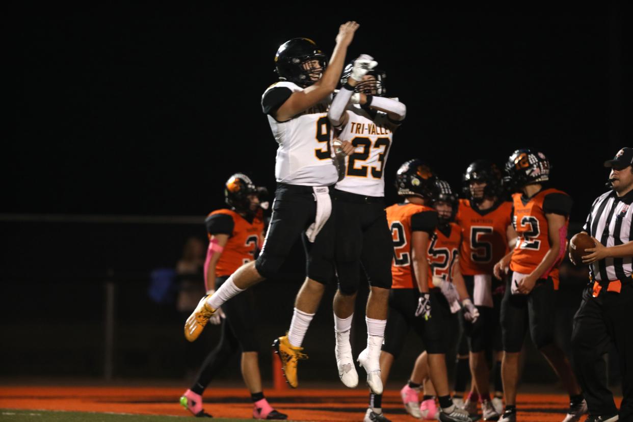 Tri-Valley's Ashton Sensibaugh (23) and Max Lyall celebrate Sensibaugh's touchdown against New Lexington.