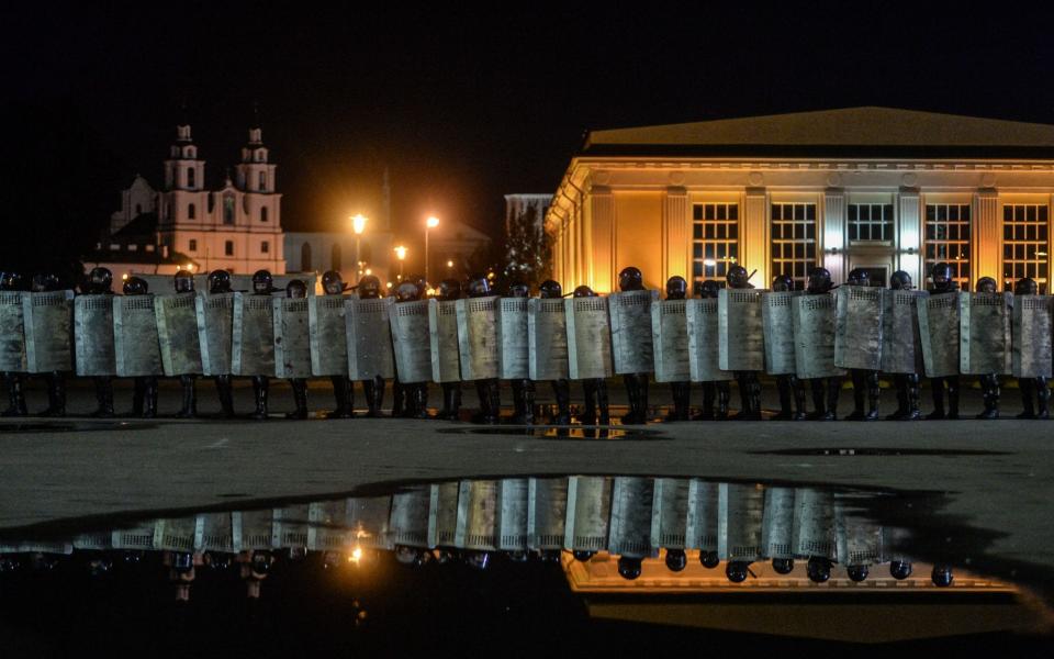 Police stand guard during a protest after polling stations closed - YAUHEN YERCHAK/EPA-EFE/Shutterstock