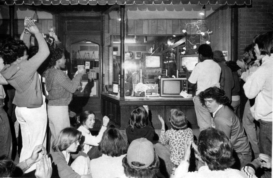 UNC fans watch the Tar Heels face Marquette in the NCAA championship game March 28, 1977. They were gathered around televisions in a storefront window on Franklin Street.