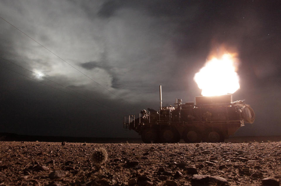 <p>A Stryker armored vehicle from the U.S. Army’s MGS Platoon, Alpha Company, 4-23 Infantry Battalion, 5th Stryker Brigade Combat Team fires a 120mm mortar during a night patrol in Kandahar, on April 27, 2010. (Photo: Tim Wimborne/Reuters) </p>