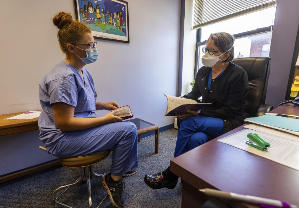 WE Health Clinic obstetrician Dr. Judith Johnson, right, talks with third-year University of Minnesota medical student Rachel Richards, Thursday, July 7, 2022 at WE Health Clinic in Duluth, Minn. Richards was on her first rotation and remarked how excited and in love she was with the work she was doing. On this day, Johnson and Richards were talking about abortions between appointments. (AP Photo/Derek Montgomery)