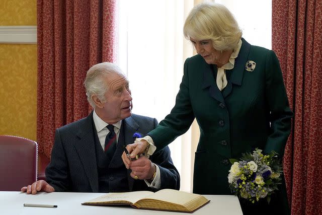 Andrew Milligan - Pool/Getty King Charles and Queen Camilla sign a visitor's book at the City Chambers in Dunfermline, Scotland in October 2022