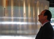 French President Francois Hollande visits the museum of Resistance at the Mont Valerien in Suresnes, West of Paris, Friday, Feb. 21, 2014, as part of a homage to French resistance fighters who fought during World War II, President Francois Hollande says two women who fought with the French Resistance during World War II will be inducted into Paris' renowned Pantheon, the eternal resting place of dozens of French greats. (AP Photo/Remy de la Mauviniere/Pool)