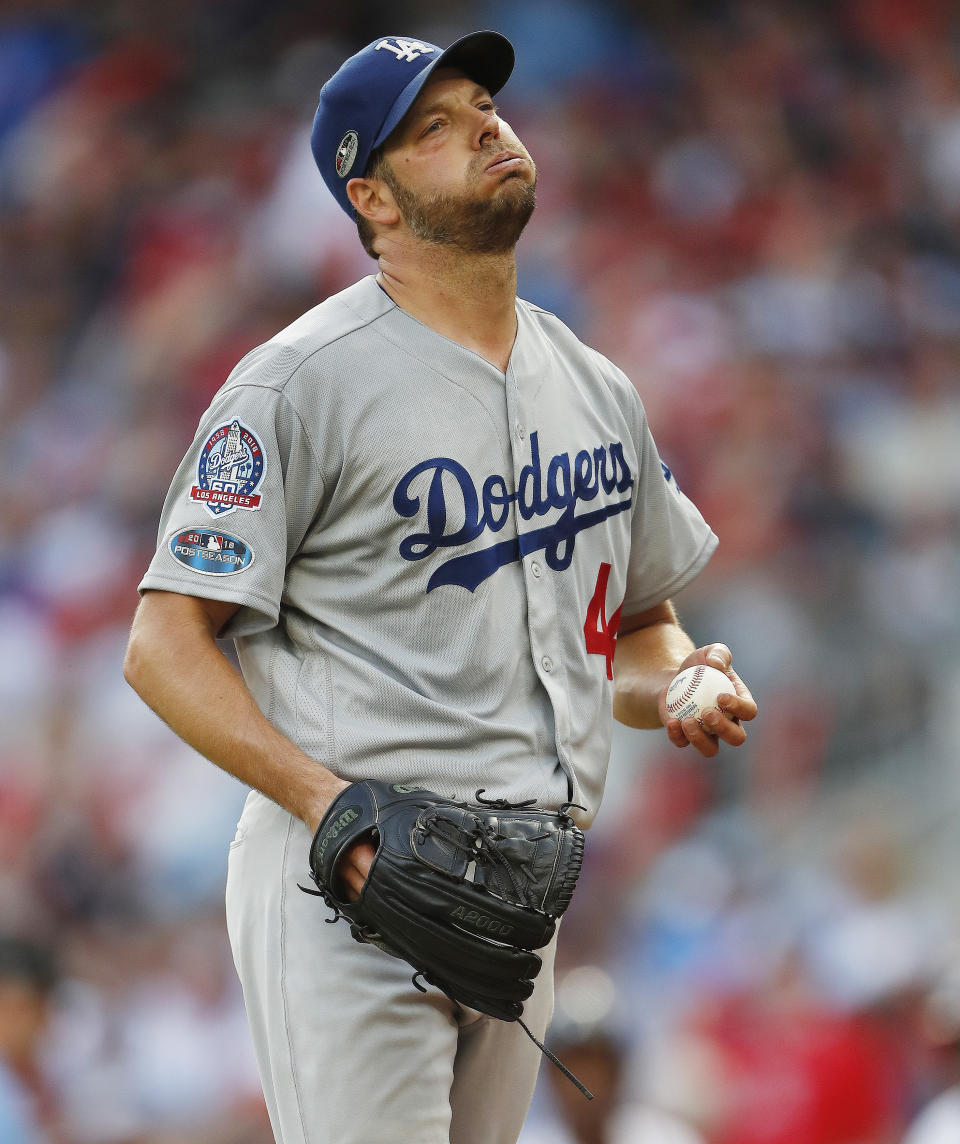 Los Angeles Dodgers starting pitcher Rich Hill (44) reacts after Atlanta Braves' Ozzie Albies hits a single during the third inning in Game 4 of baseball's National League Division Series, Monday, Oct. 8, 2018, in Atlanta. (AP Photo/John Bazemore)