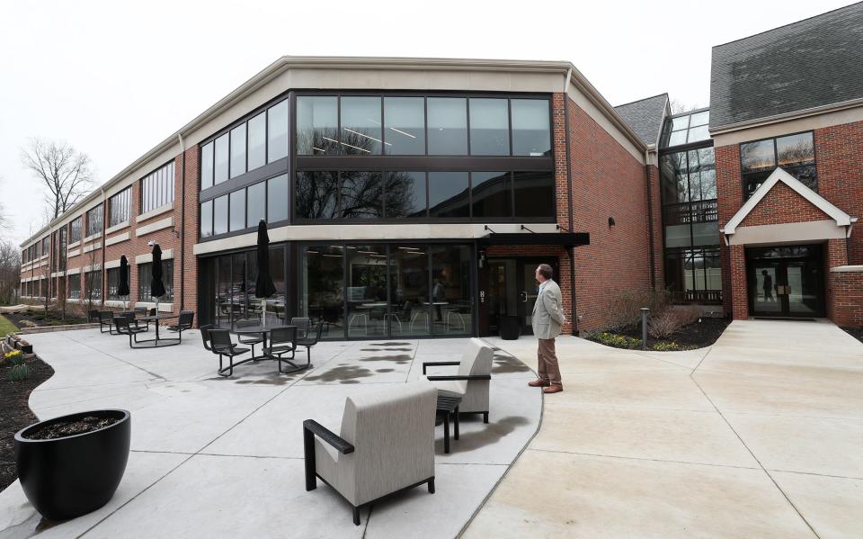 Brad Ehrhart, president of the Portage Development Board, admires the exterior of the newest addition to The Davey Tree Expert Company's recently renovated headquarters and the expanded facility during an open house and tour of the facility Friday in Kent.