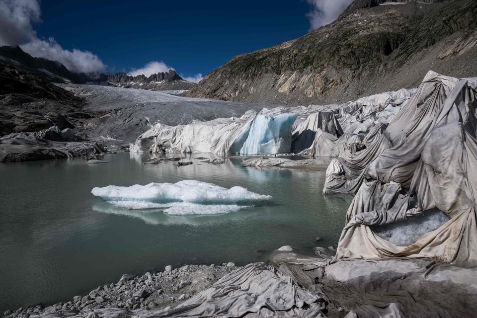 This photograph taken near Gletsch, in the Swiss Alps, on July 8, 2022 shows insulating foam covering a part of the Rhone Glacier to prevent it from melting next to its glacial lake.