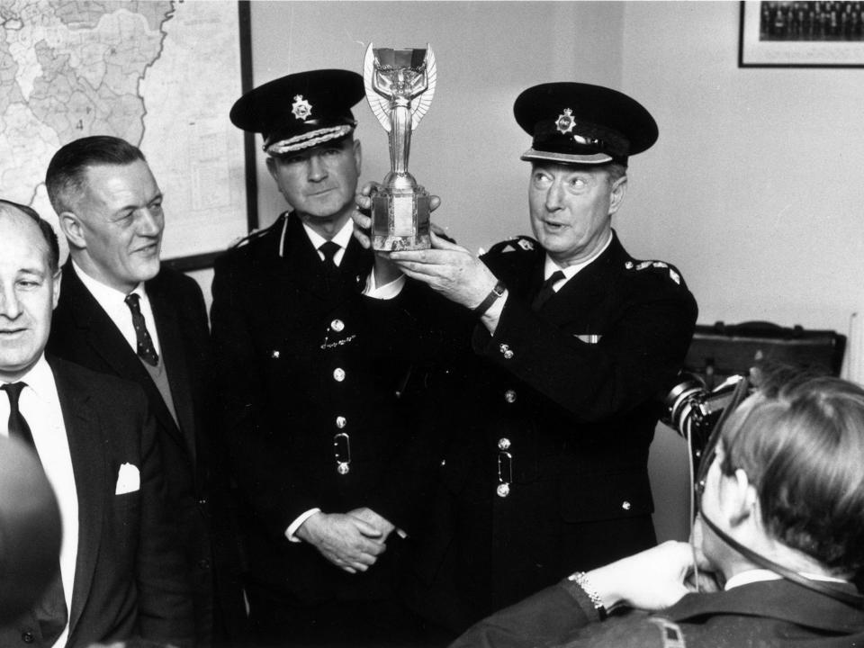 London police with the Jules Rimet trophy after it was found by Pickles the dog following its initial disappearance: Getty