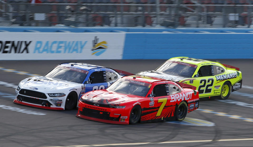 Justin Allgaier (7) and Chase Briscoe (98) race through Turn 4 ahead of Austin Cindric (22) during a NASCAR Xfinity Series auto race at Phoenix Raceway, Saturday, Nov. 7, 2020, in Avondale, Ariz. (AP Photo/Ralph Freso)