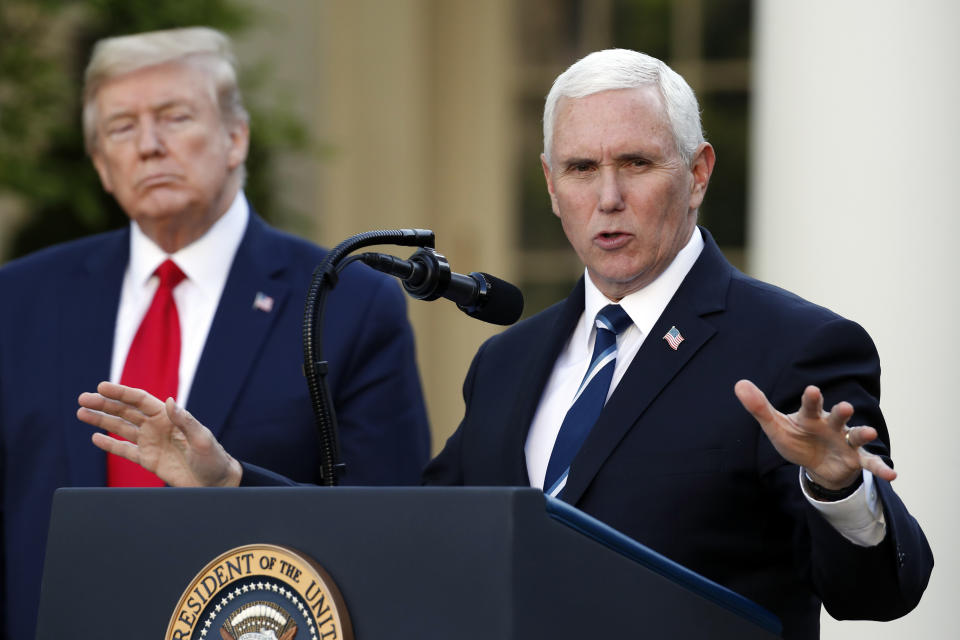 President Donald Trump listens as Vice President Mike Pence speaks about the coronavirus in the Rose Garden of the White House on April 27, 2020, in Washington. (Alex Brandon/AP)