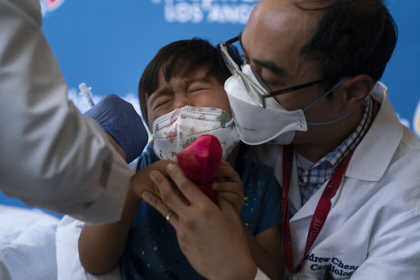 Callum Diaz-Cheng, 3, reacts in the arms of his father, Dr. Andrew Cheng, after receiving the Pfizer COVID-19 vaccine at Children's Hospital Los Angeles in Los Angeles, Tuesday, June 21, 2022. (AP Photo/Jae C. Hong)