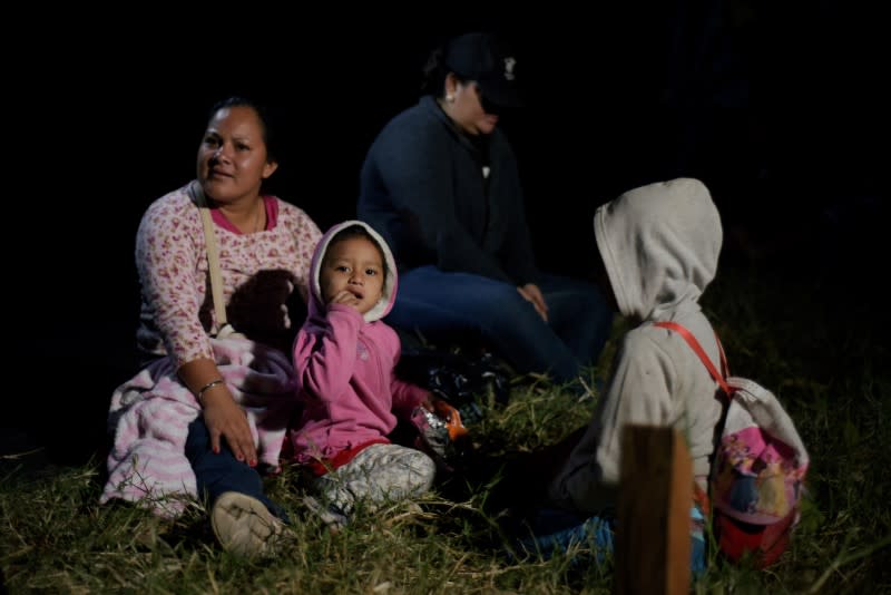 People, part of a caravan of migrants heading toward the United States, rest at the border between Honduras and Guatemala in Agua Caliente