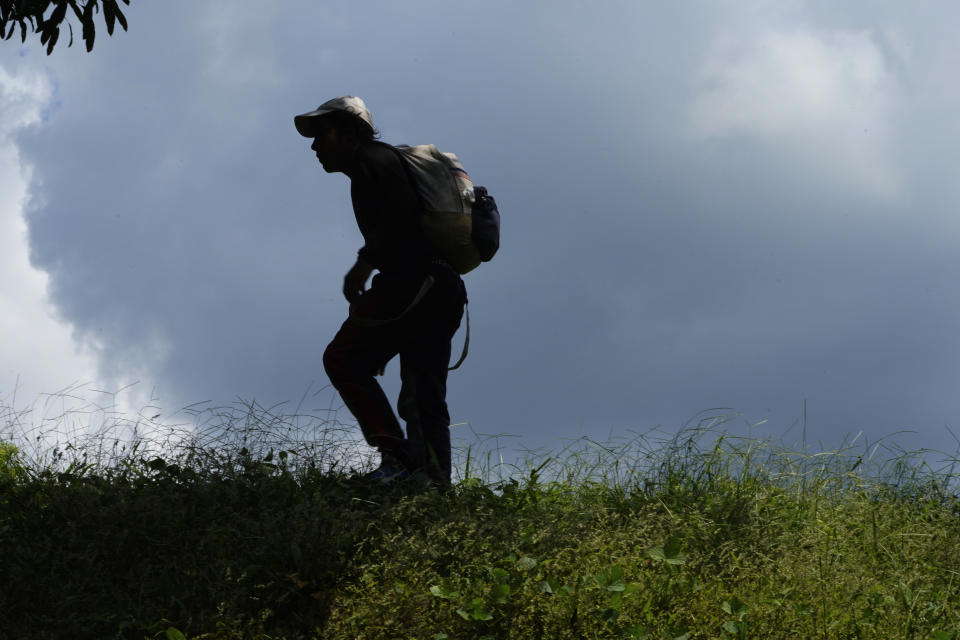 A migrant, who is part of a migrant caravan headed to the U.S border, arrives in Villa Comaltitlan, Chiapas state, Mexico, Wednesday, Oct. 27, 2021. (AP Photo/Marco Ugarte)