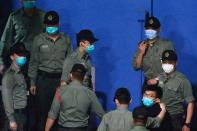 Pro-democracy activist Joshua Wong looks on upon arriving at Lai Chi Kok Reception Centre after he remained in custody over the national security law charge, in the early morning, in Hong Kong