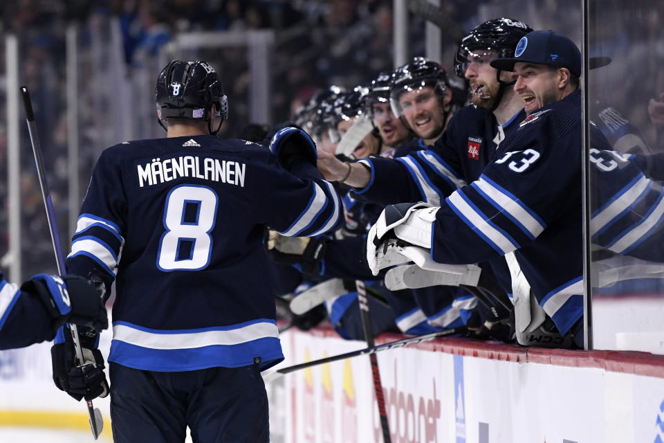 Winnipeg Jets' Saku Maenalanen (8) celebrates his goal against the Dallas Stars with teammates during the second period of an NHL hockey game, Tuesday, Nov. 8, 2022 in Winnipeg, Manitoba. (Fred Greenslade/The Canadian Press via AP)