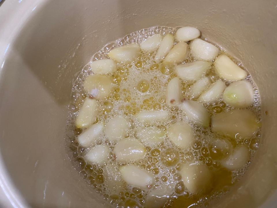 garlic cooking in butter in a pot on the stove