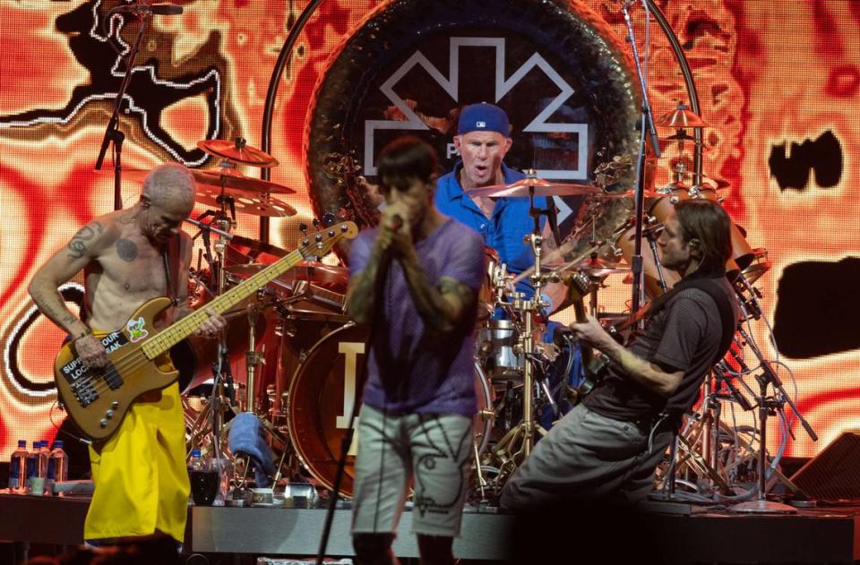 Red Hot Chili Peppers bassist Flea, left, and and guitarist John Frusciante play together while lead vocalist Anthony Kiedis sings at the Toyota Amphitheatre near Wheatland on Sunday, June 2, 2024.