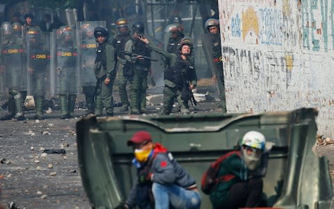 Protesters in the border town of Ureña and San Antonio were bombarded by tear gas and rubber bullets from dawn - Credit: Fernando Llano/AP