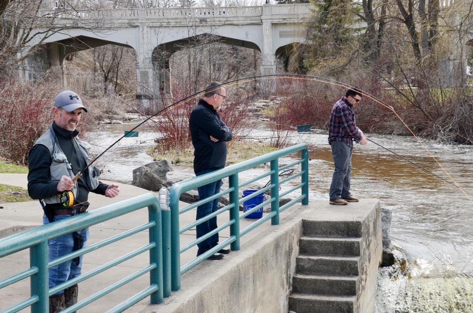 Fishermen try their luck in the Bear River near the Mitchell Street Bridge in Petoskey.