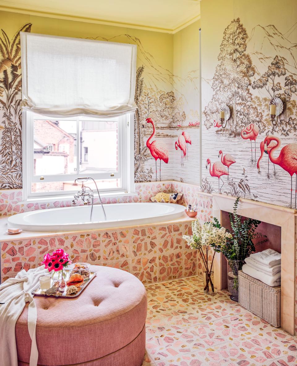 In the maximalist master bath, terrazzo flooring joins a de Gournay wall covering on sterling-silver gilded paper. Ilbagnoalessi tub; Catchpole & Rye tub filler.