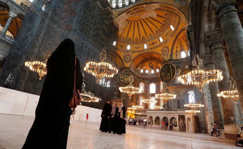 Visitors pose for a picture at Hagia Sophia or Ayasofya, a UNESCO World Heritage Site, in Istanbul