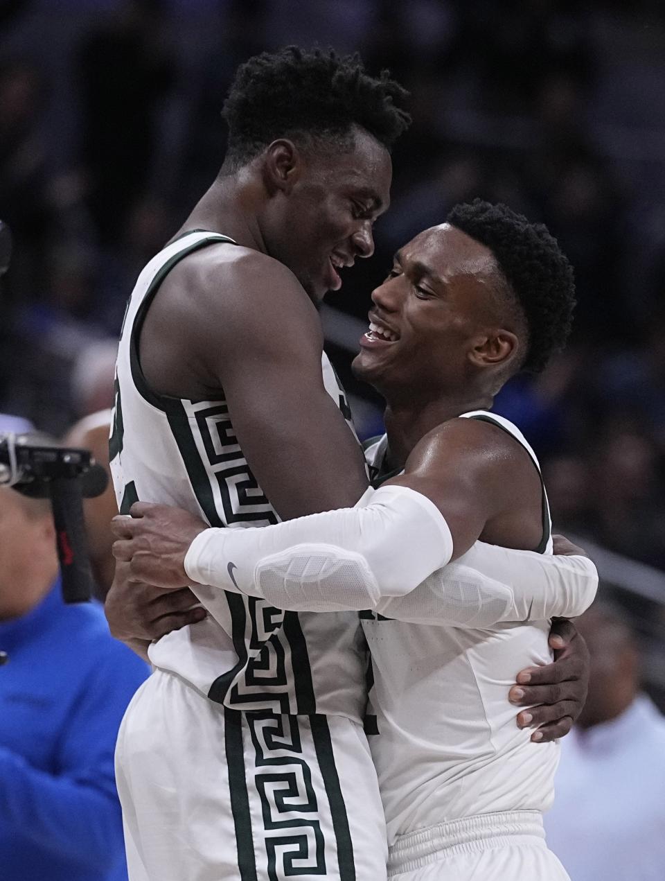 Michigan State center Mady Sissoko, left, celebrates with teammate Tyson Walker, right, after their overtime win over Kentucky in an NCAA college basketball game, Tuesday, Nov. 15, 2022, in Indianapolis.