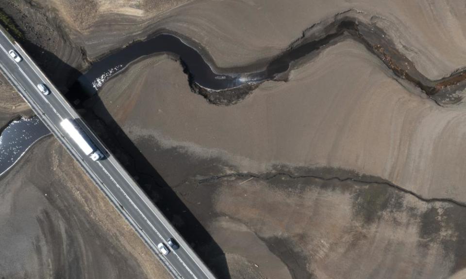 Vehicles cross a bridge over Woodhead reservoir in West Yorkshire