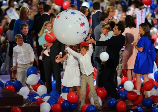 Sam Ryan plays with a giant balloon as the families of Republican presidential candidate Mitt Romney and vice presidential candidate, Paul Ryan stand on stage during the final day of the Republican National Convention at the Tampa Bay Times Forum on August 30, in Tampa, Florida