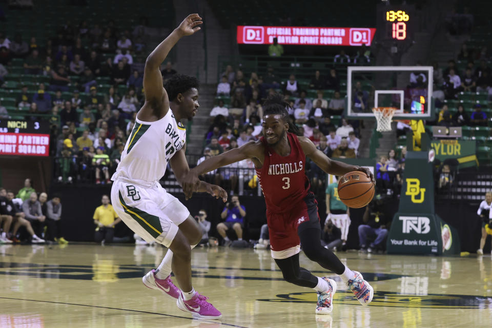 Nicholls State guard Micah Thomas (3) drives against Baylor guard Adam Flagler during the first half of an NCAA college basketball game Wednesday, Dec. 28, 2022, in Waco, Texas. (AP Photo/Jerry Larson)