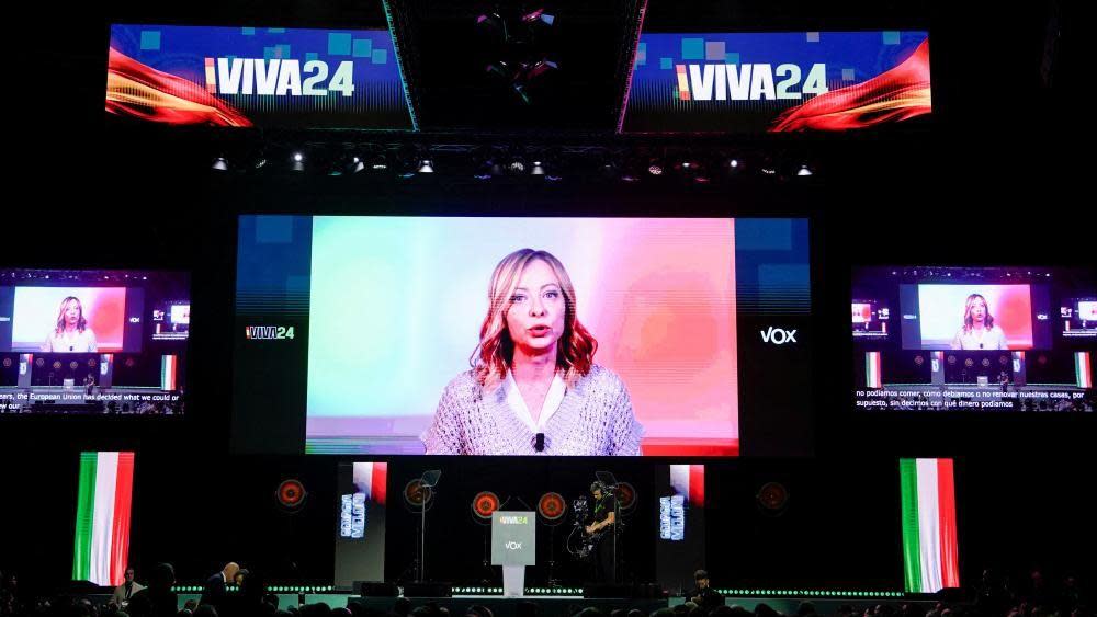 Italian Prime Minister Giorgia Meloni speaks via video link during a rally organised by the Spanish far-right Vox party ahead of the European elections