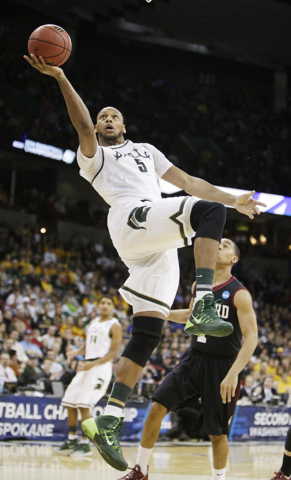 Michigan State’s Adreian Payne (5) shoots a layup in the first half during the third-round game of the NCAA men's college basketball tournament against Harvard in Spokane, Wash., Saturday, March 22, 2014. (AP Photo/Young Kwak)
