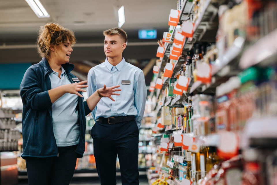 grocery store manager talking with an employee