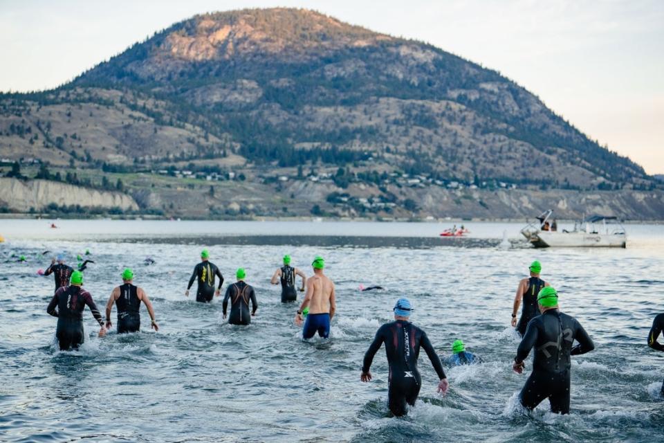 Athletes compete at the start of the swim at Ironman Canada in August 2022. 