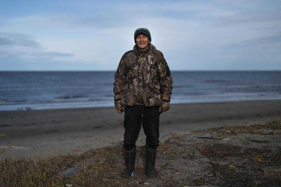 John Sinnok, 73, stands for a photo with the Arctic Ocean behind him in Shishmaref, Alaska, Wednesday, Oct. 5, 2022. (AP Photo/Jae C. Hong)