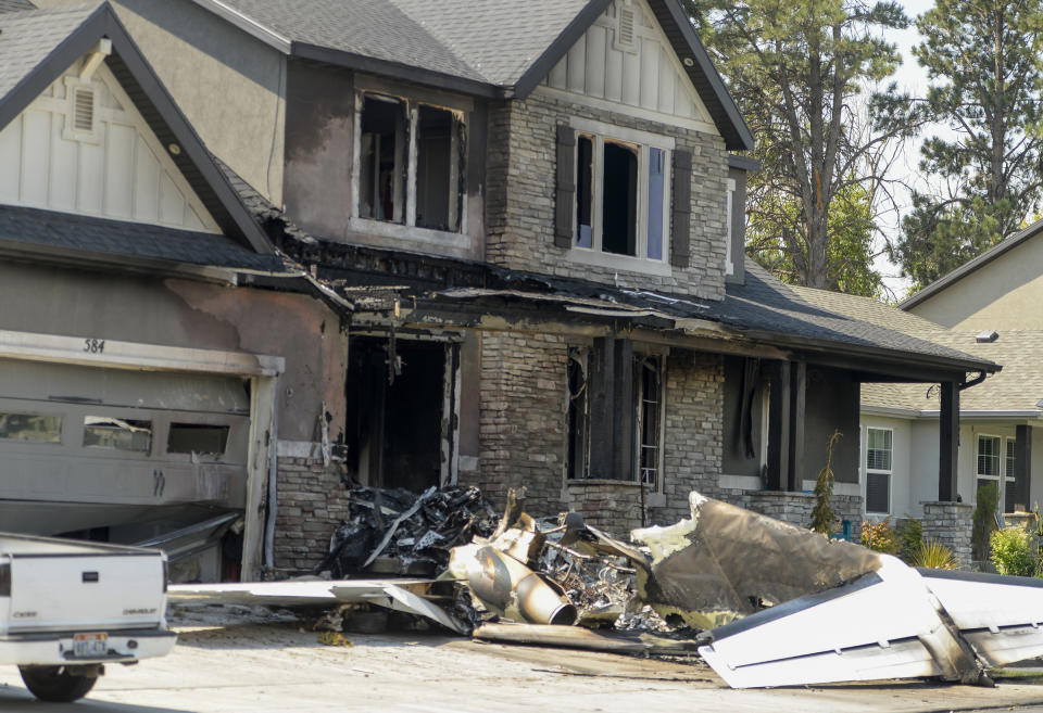 This photo shows a damaged house after a plane crashed in Payson, Utah, Monday, Aug. 13, 2018. A Utah man flew the small plane into his own house early Monday just hours after he had been arrested for assaulting his wife in a nearby canyon where the couple went to talk over their problems, authorities said. (Leah Hogsten/The Salt Lake Tribune via AP)