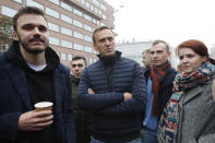Russian opposition leader Alexei Navalny, centre, surrounded by members of his team, attends a rally to support political prisoners in Moscow, Russia, Sunday, Sept. 29, 2019. (AP Photo/Dmitri Lovetsky)