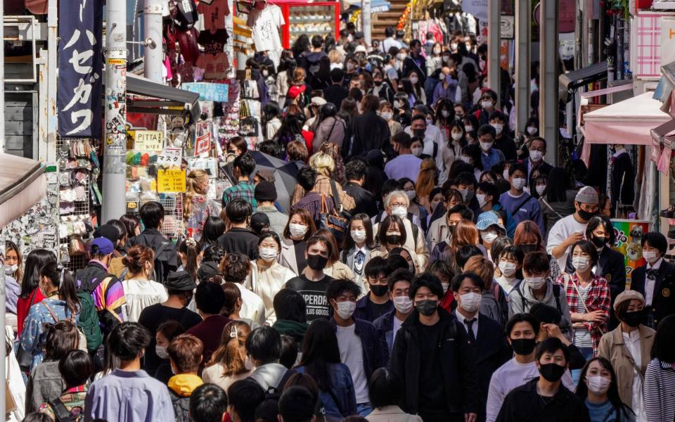 People wearing protective masks swarm the Takeshita Street at Harajuku, a youngster fashion town In Tokyo - KIMIMASA MAYAMA/EPA-EFE/Shutterstock