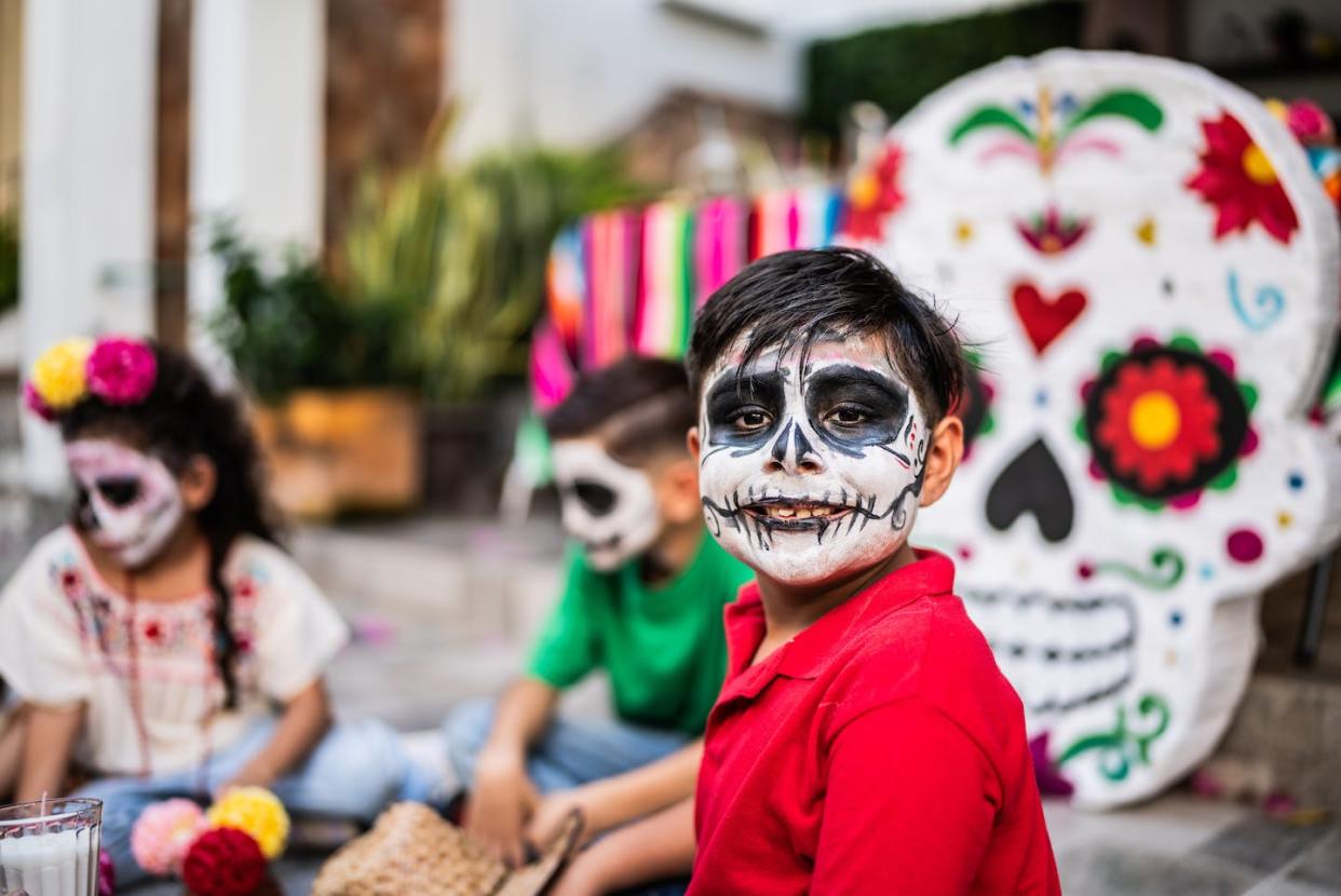 Children trick or treat and wear Halloween costumes for a full week during Day of the Dead season in Mexico. <a href="https://www.gettyimages.com/detail/photo/portrait-of-boy-with-sugar-skull-face-paint-during-royalty-free-image/1653069265?phrase=mexico+day+of+the+dead+people&adppopup=true" rel="nofollow noopener" target="_blank" data-ylk="slk:FG Trade Latin/Collection E+ via Getty Images;elm:context_link;itc:0;sec:content-canvas" class="link ">FG Trade Latin/Collection E+ via Getty Images</a>