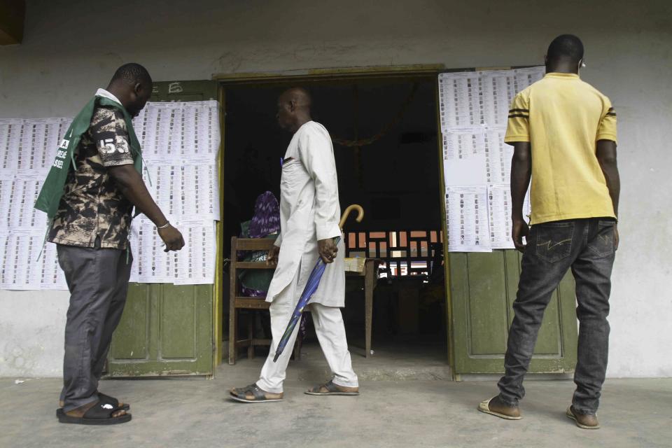 Malians living in the Ivory Coast, gather at a polling station before casting their ballot on a new Malian draft constitution, in Abidjan, Sunday, June 18, 2023. Malian voters cast ballots on a new draft constitution Sunday in a referendum that the country's coup leader says will pave the way toward holding new elections in 2024, but that critics have called a delaying tactic for him to extend his time in power. (AP Photo/Diomande Ble Blonde)