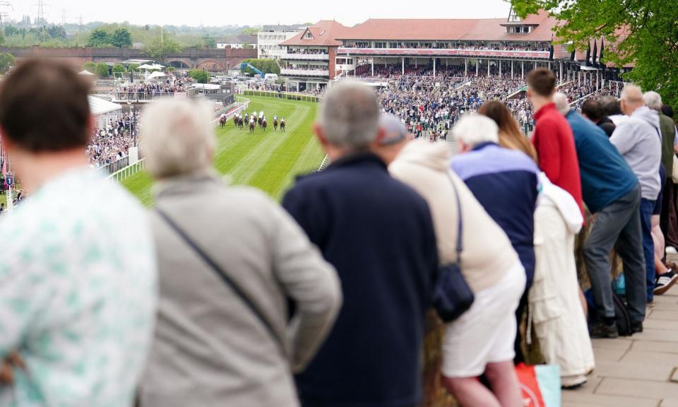 <span>Racing fans watch the action at Chester this week from the Roman walls.</span><span>Photograph: Mike Egerton/PA</span>