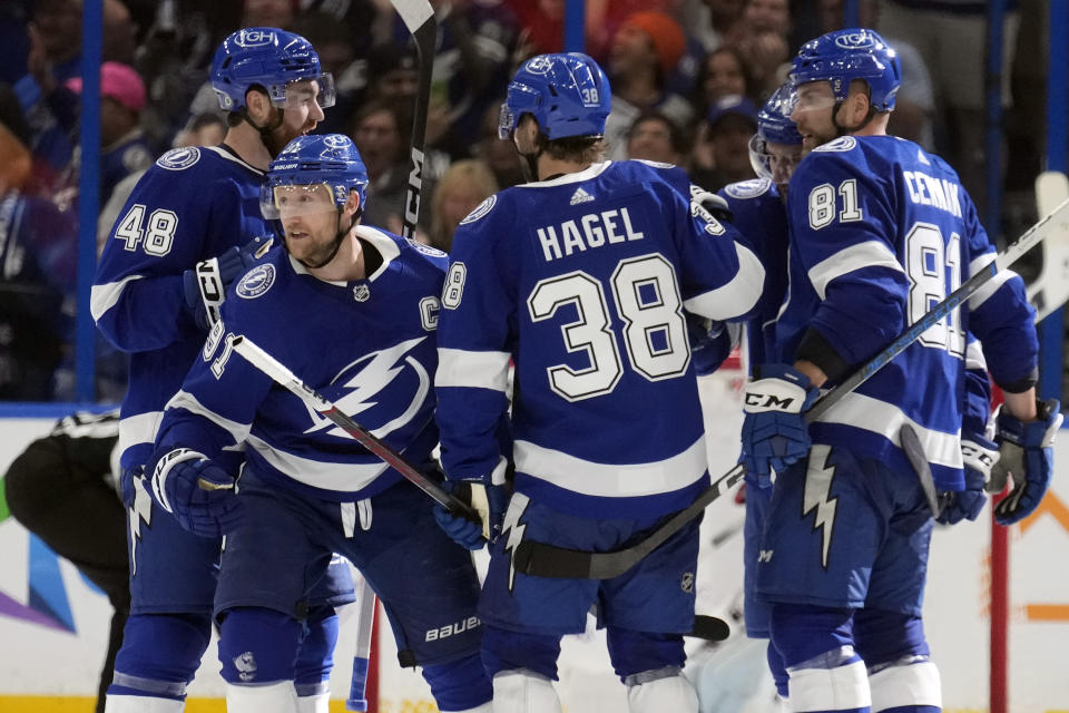 Tampa Bay Lightning center Steven Stamkos (91) celebrates his goal against the Columbus Blue Jackets with defenseman Nick Perbix (48), left wing Brandon Hagel (38), and defenseman Erik Cernak (81) during the third period of an NHL hockey game Tuesday, April 9, 2024, in Tampa, Fla. (AP Photo/Chris O'Meara)